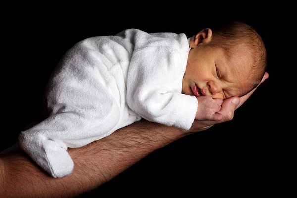 newborn baby on arm