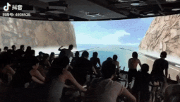 This gym has a giant simulator screen to keep people entertained while cycling.