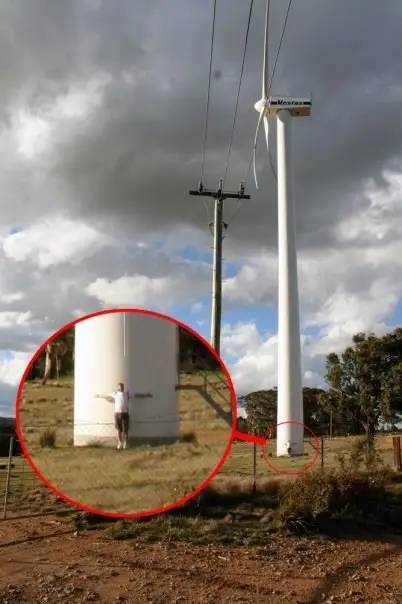 this is a person next to a wind turbine