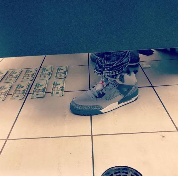 bathroom stall with money on the floor