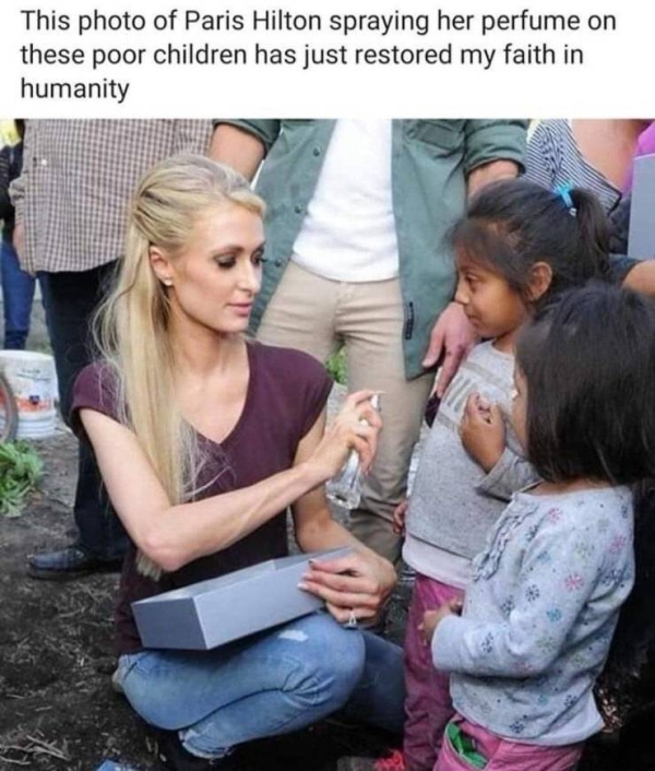 paris hilton spraying perfume on poor children - This photo of Paris Hilton spraying her perfume on these poor children has just restored my faith in humanity