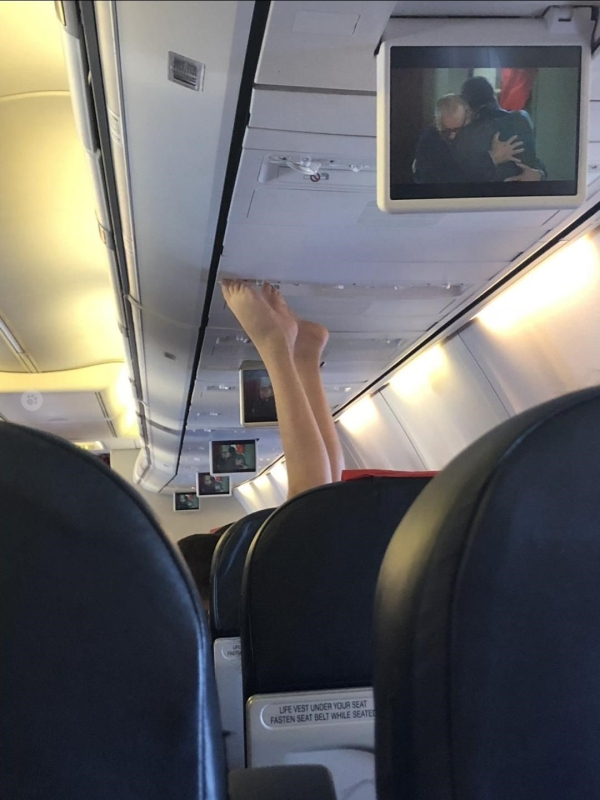 feet on airplane - Ufe Vest Under Your Seat Fasten Seat Belt While Seatee