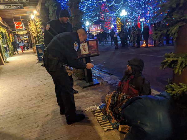 “In Santa Fe for NYE. Police handing out food to the homeless.”