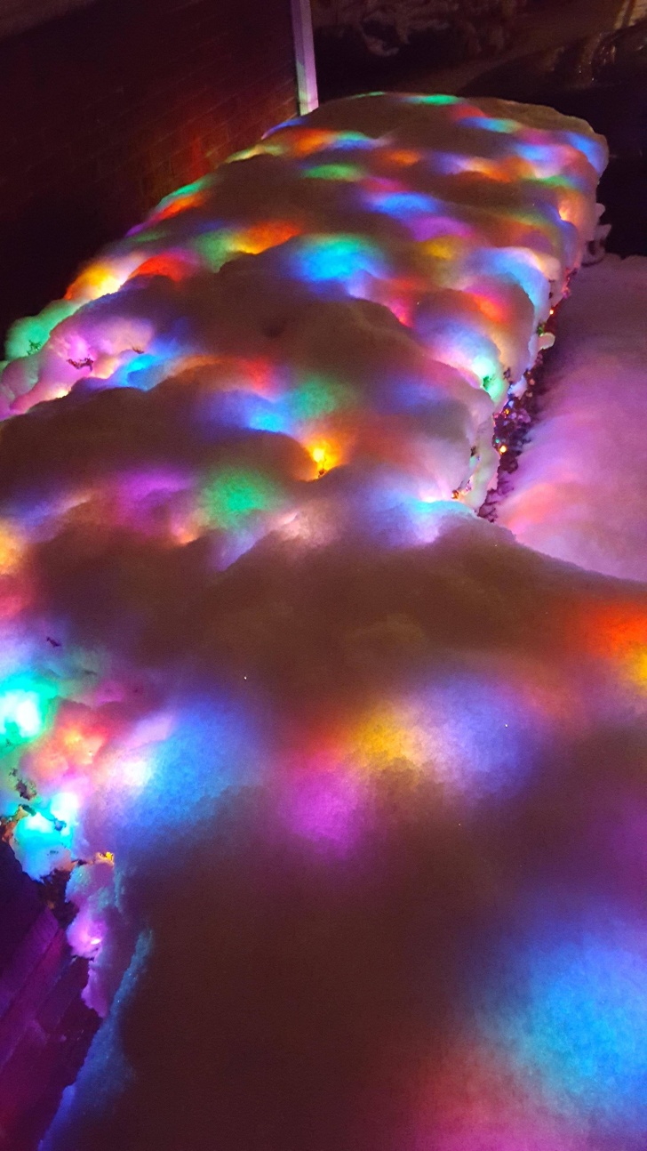 colored christmas lights in snow