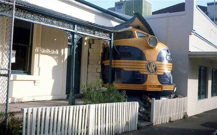 train crashes through house