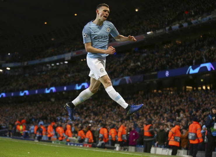Soccer player heading a ball in a perfectly timed photo at the Etihad Stadium