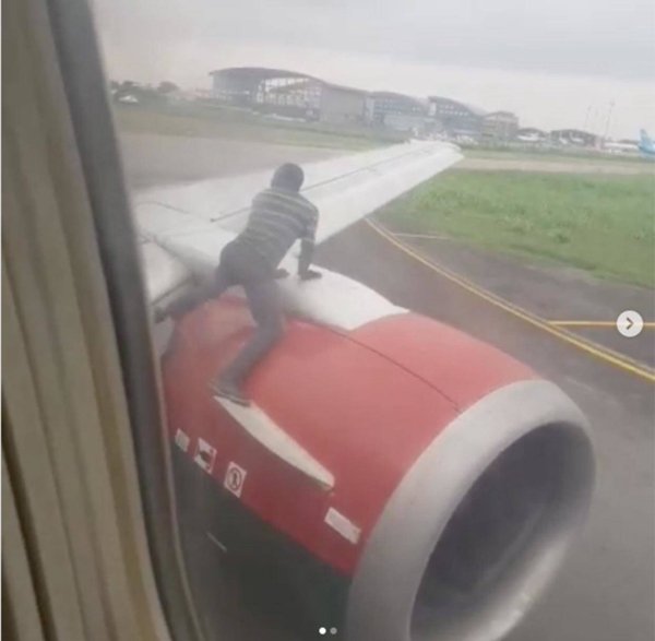 man jumps on plane wing