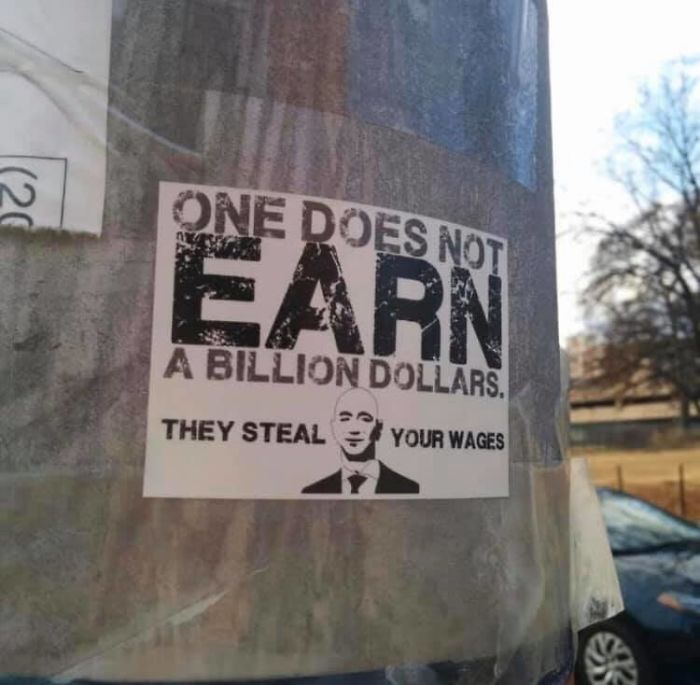 signage - One Does Not Arn A Billion Dollars. They Steal Your Wages
