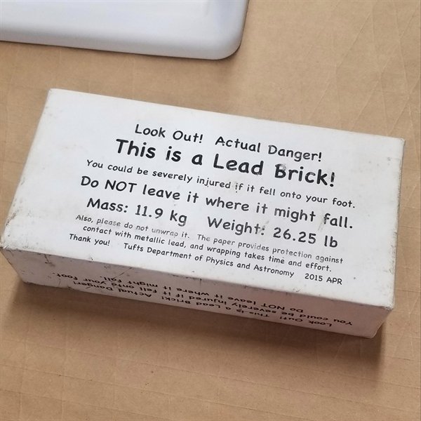 box - Look Out! Actual Danger! This is a Lead brick! You could be severely injured if it fell onto your foot. Do Not leave it where it might fall. Mass 11.9 kg Weight 26.25 lb Also, please do not unwrap it. The paper provides protection against contact wi