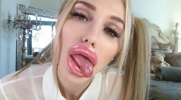 Woman with massive lip injections sticking her tongue out
