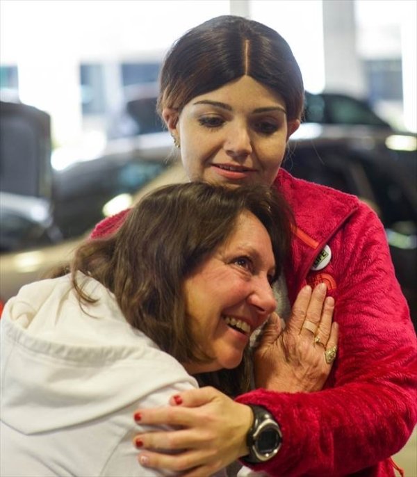 mother listening to deceased son's heartbeat