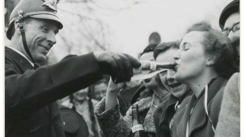 Officer gives drink support at carnival in Düsseldorf, Germany, 1930