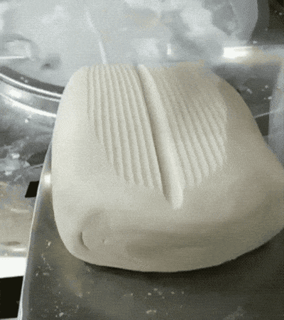 Dough Being Cut Into Noodles.