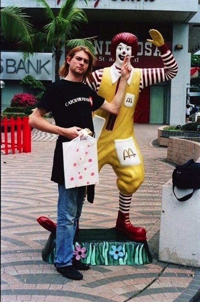 Kurt Cobain having a smoke with Ronald McDonald in Singapore, 1992.