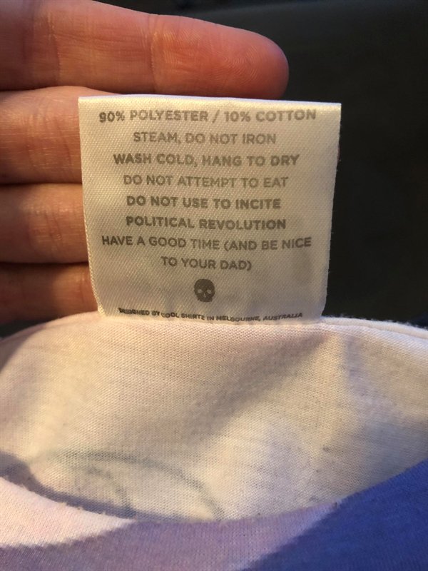 close up - 90% Polyester 10% Cotton Steam, Do Not Iron Wash Cold, Mang To Dry Do Not Attempt To Eat Do Not Use To Incite Political Revolution Have A Good Time And Be Nice To Your Dad Wool Shirte In Sourne, Aus