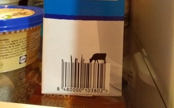 This milk carton bar code has a cow eating from the outgrown bars