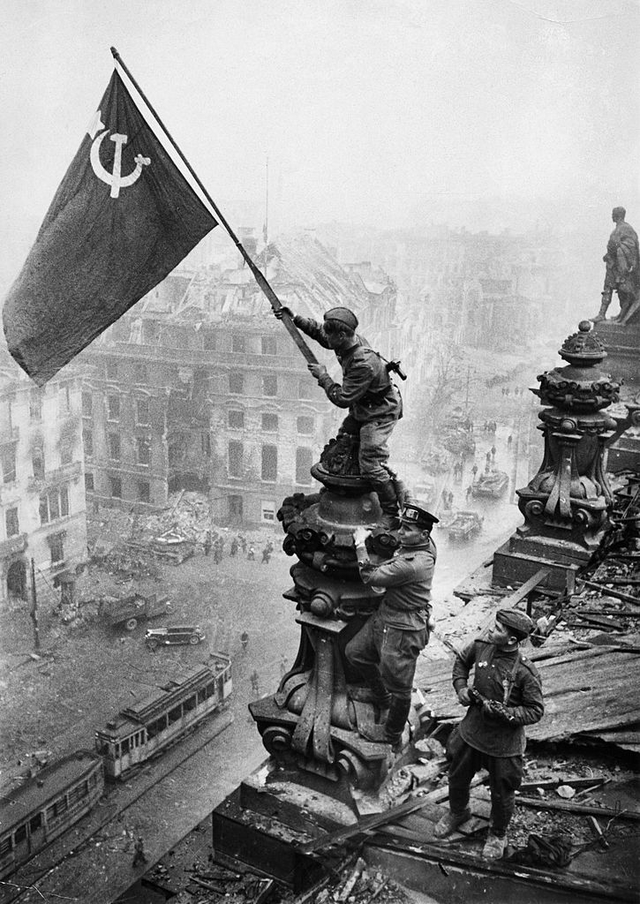 Soviet soldiers raises soviet flag over the Reichstag, Berlin, Germany. 1945