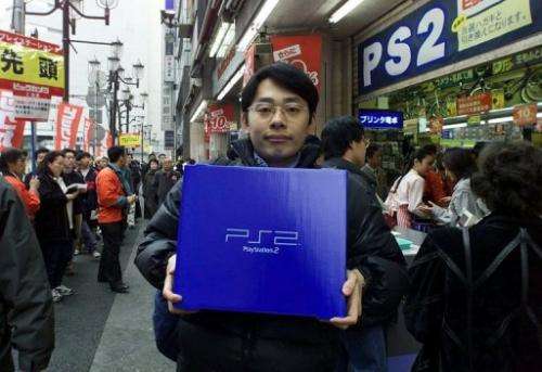 Japanese man holding his newly adquired PS2 in Launch Day in Japan, March 4, 2000