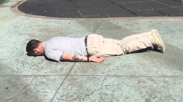 person laying on sidewalk