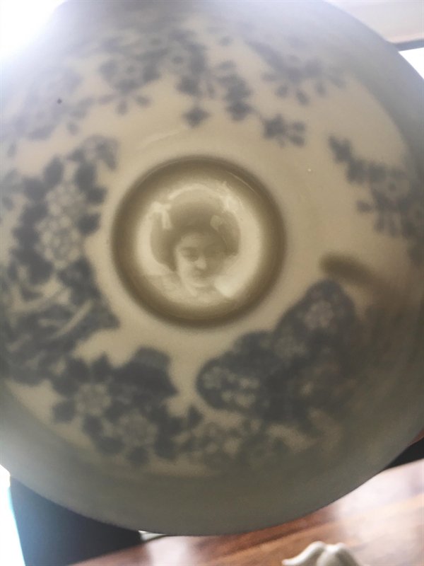 porcelain teacup showing drawing of woman's face