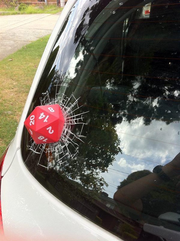 car windshield with 3D sticker on it made to look like a ball cracked the windshield