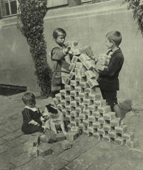 Children use bundles of German marks as play building blocks c1923 as the currency becomes almost worthless after World War One.