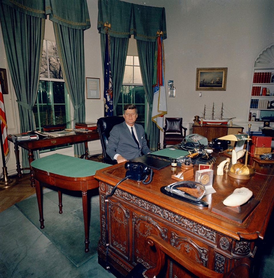 President Kennedy taking a break at the end of the day at his Oval Office desk (1962)