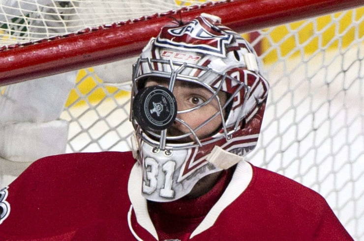carey price eye on the puck - goalie with hockey puck in his mask