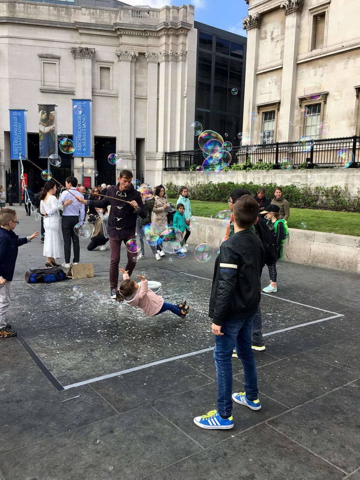 little girl falling in a puddle of bubbles