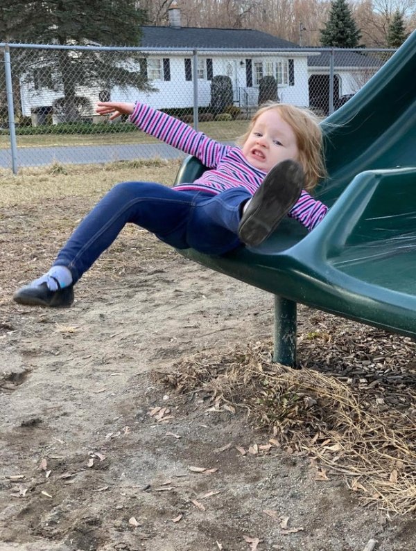 perfectly timed photos - girl falling off slide