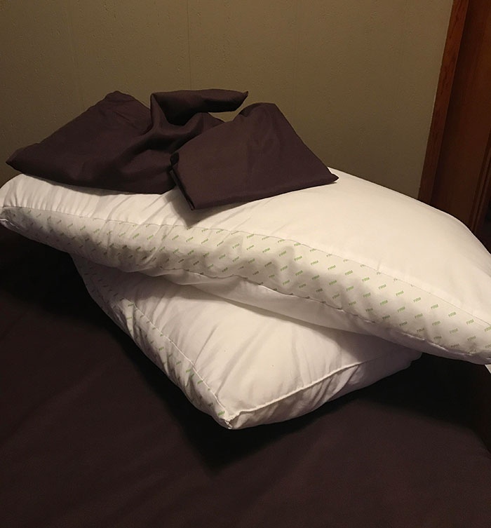 pillows on a bed with pillowcases on top