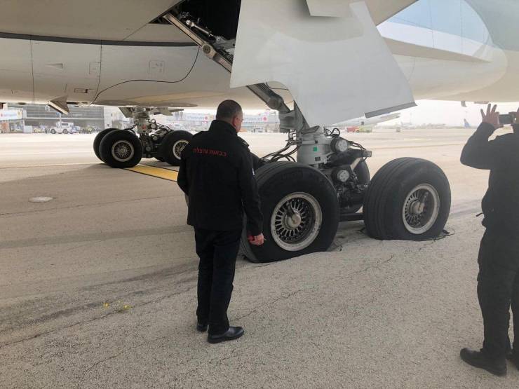 a350 airplane grounded with wheel stuck in a pothole