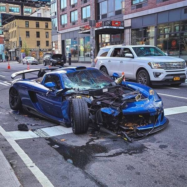 blue porsche smashed on the street