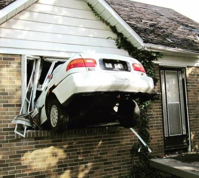 car that drove through living room window of a house