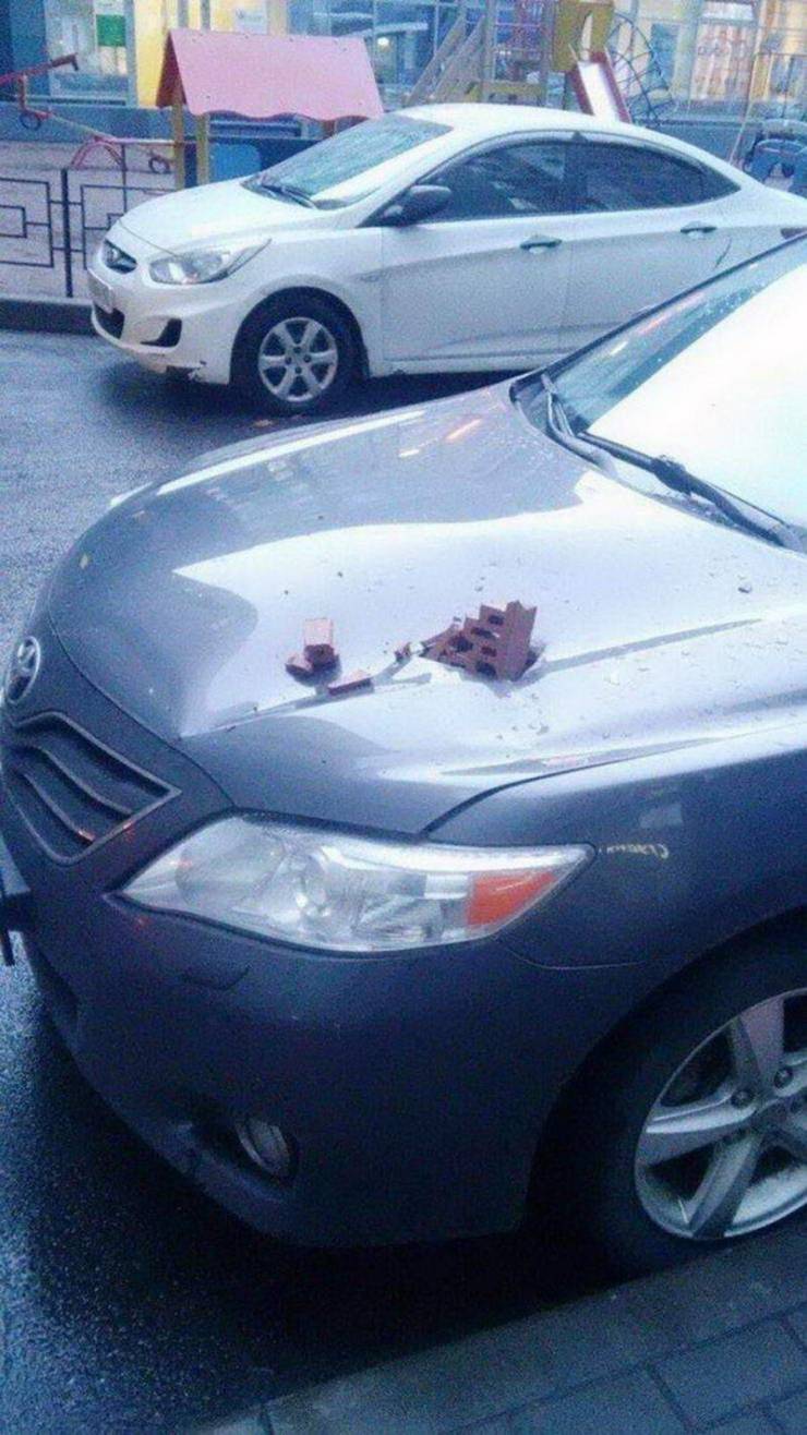 brick makes a hole in a car hood