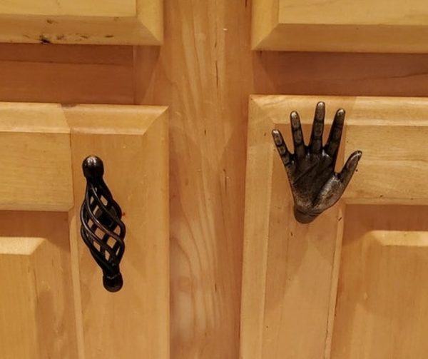 kitchen cabinet handle shaped like a little metal hand