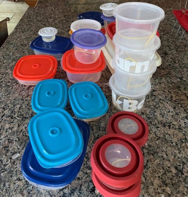 tupperware containers with one piece of spaghetti in each of them