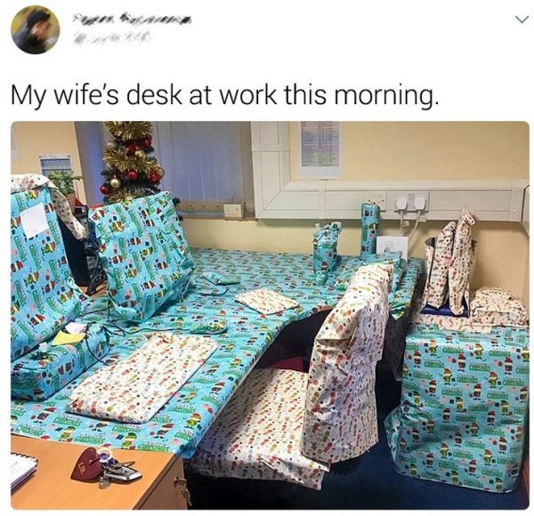 My wife's desk at work this morning - gift wrap office furniture prank