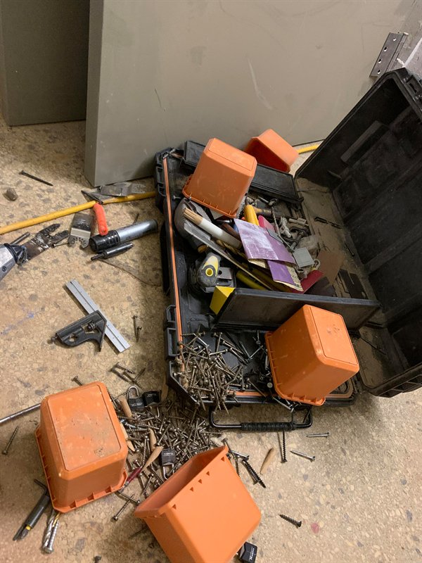 tool box with lots of nails and screws and hardware fell and spilled all over the ground