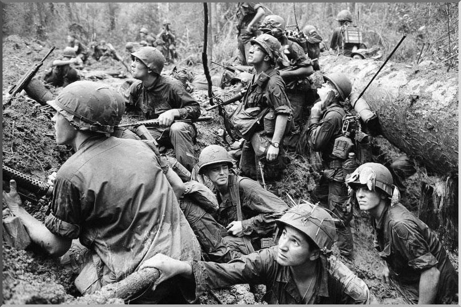 June 15, 1967 American soldiers peer out of the trench to evade Viet Cong snipers during fighting in the north-east of Saigon.