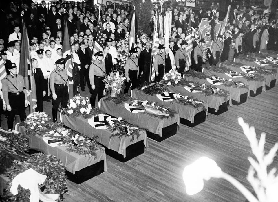 Nazi flags drape over the coffins of victims of the Hindenburg disaster in New York, USA on May 11, 1937