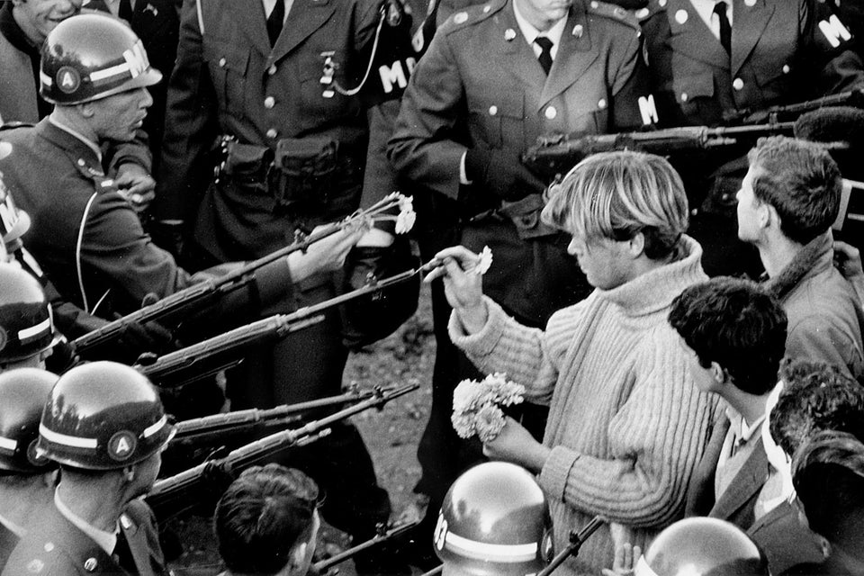 A protestor inserting a flower as a symbol of peace (flower power) into the barrel of a soldier’s rifle in Arlington, Virginia, on Oct. 26, 1967.