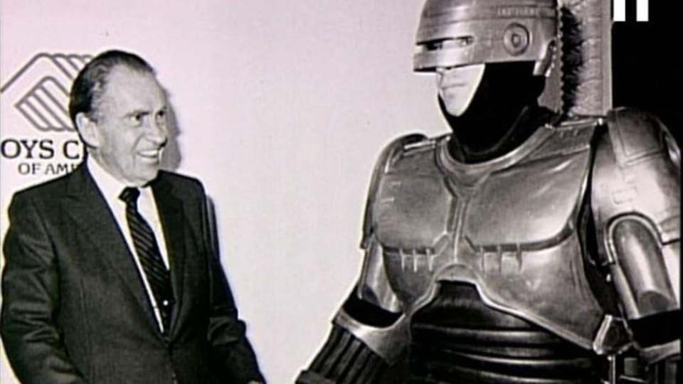 Former President Richard M. Nixon meets a RoboCop cosplayer during an event for the Boys Club of America in collaboration with Orion Pictures ahead of the VHS release of "RoboCop", 1987