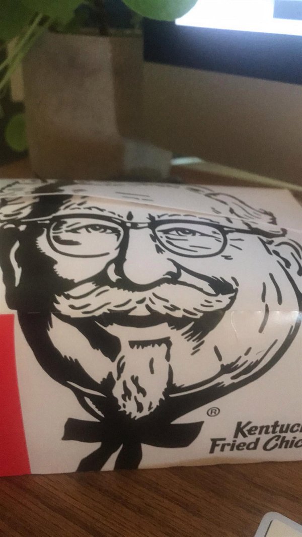 kentucky fried chicken box makes colonel sanders' face look fat and distorted