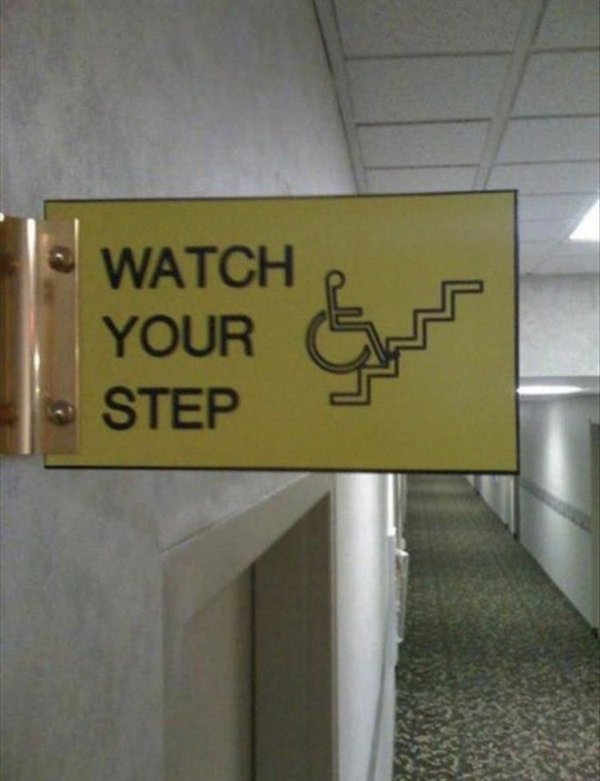 watch your step sign with wheelchair guy falling down the stairs backwards