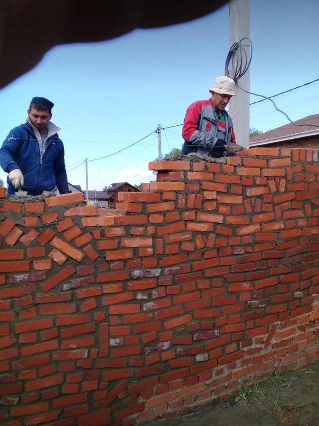 brick wall made with bricks that are fallen over