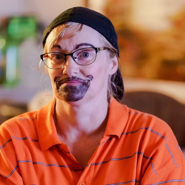 woman dressed up as silly looking man with fake beard drawn on with sharpie