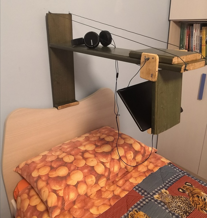 wooden contraption so kid can watch video monitor while laying in bed