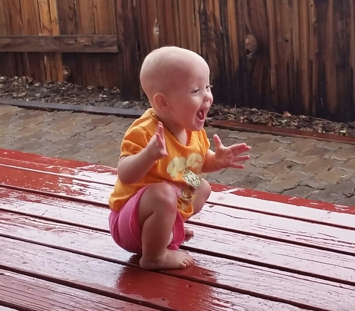 “My daughter playing in and seeing rain for the first time yesterday”