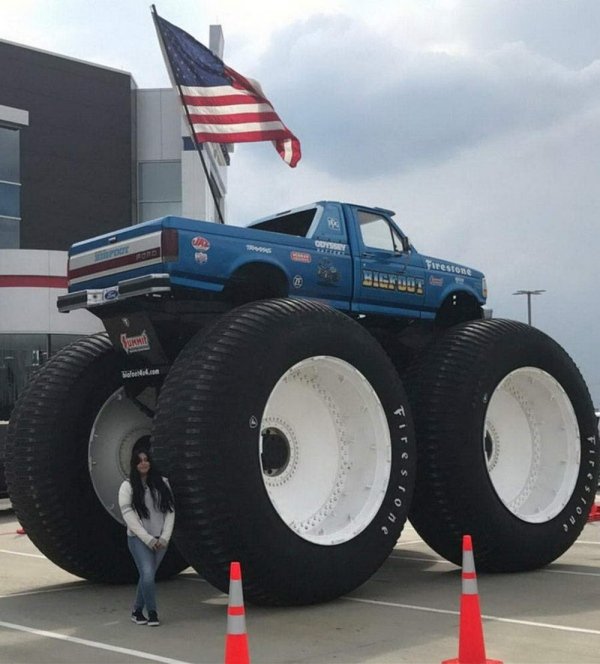 huge blue big wheel truck with american flag